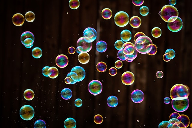 Photo of colorful bubbles against a dark background.